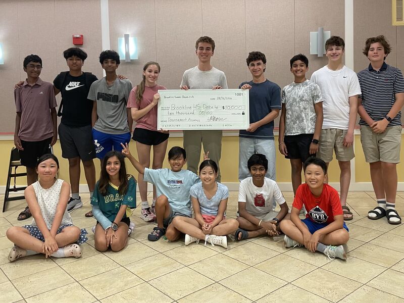 Brookline Debate Club students presenting a $10,000 check to support Brookline High School debate
